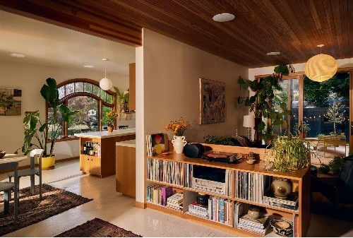 Sonos In-Ceiling Speaker model INCL8WW1 shown in a modern open-concept home with wooden accents, plants, and natural light, blending seamlessly into the ceiling for discreet, built-in audio.
