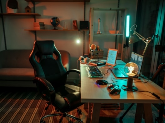 Gaming room featuring lighting around the chair, desk, and gaming computer