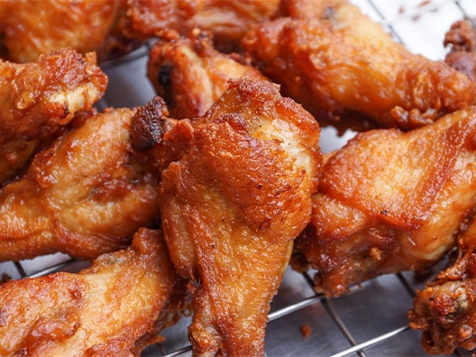 Closeup of Buffalo wings on air fry grate