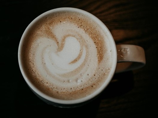 Overhead view of a cappuccino with swirly foam on top