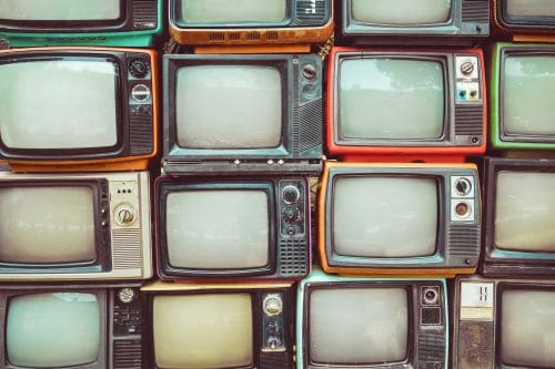 Stacks and rows of 1970s-era TVs